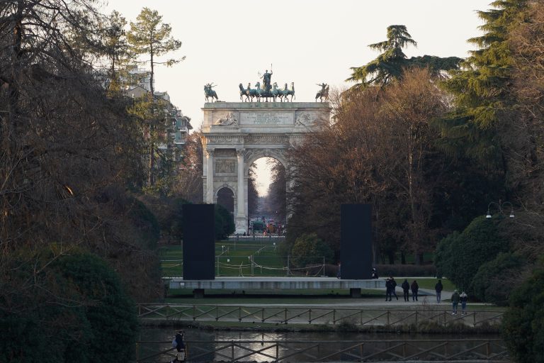 Arco della Pace, or the Arch of Peace in English. It is a neoclassical monument that was built in the early 19th century to celebrate the end of the Napoleonic Wars and the restoration of peace in Europe. The Arch of Peace is located at the end of the beautiful Parco Sempione, a large park that surrounds the Sforza Castle and is one of the largest green spaces in Milan.