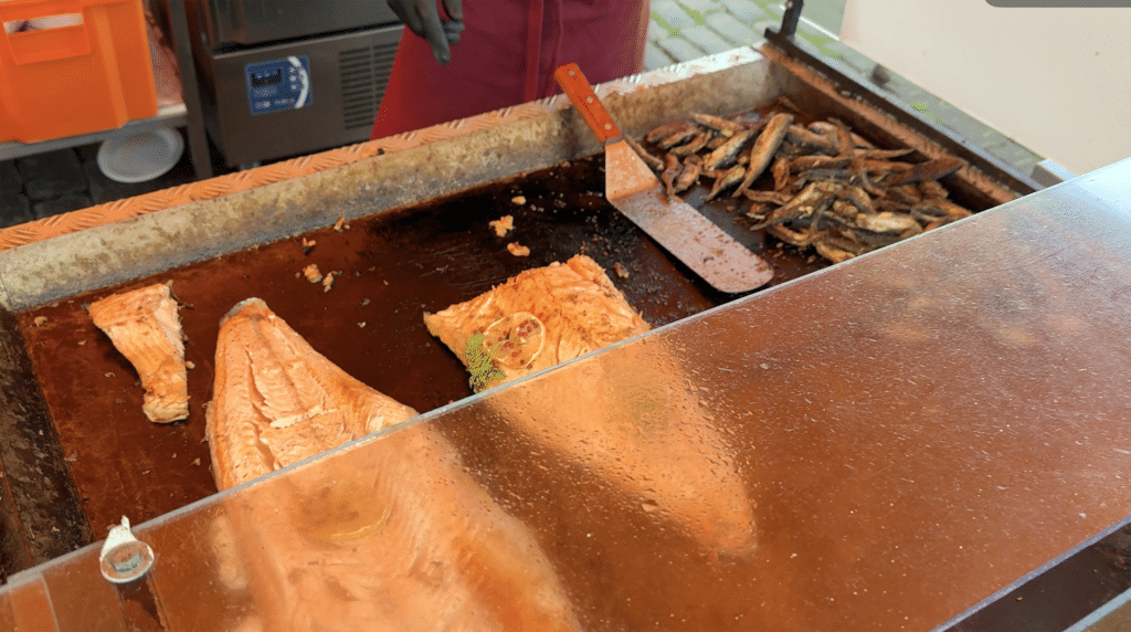 Grilled salmon fillets with lemon and pink peppercorns at a Helsinki harbor food stall