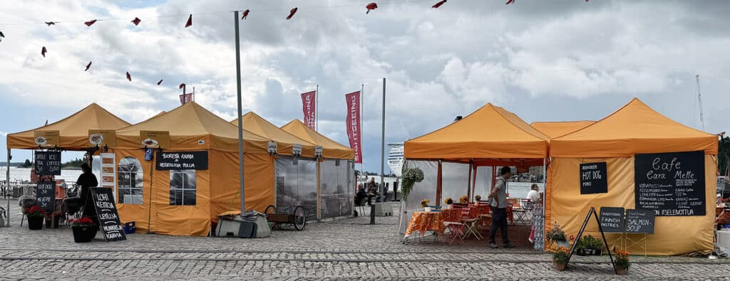 Orange food tents at Helsinki's Market Square harbor food stalls