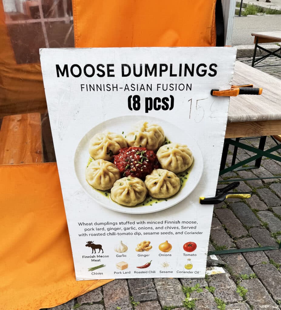 Sign advertising Finnish moose dumplings, a Finnish-Asian fusion dish, at a Helsinki market stall