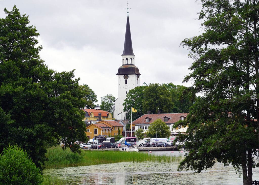 Mariefred church steeple rising above the harbor and yellow houses