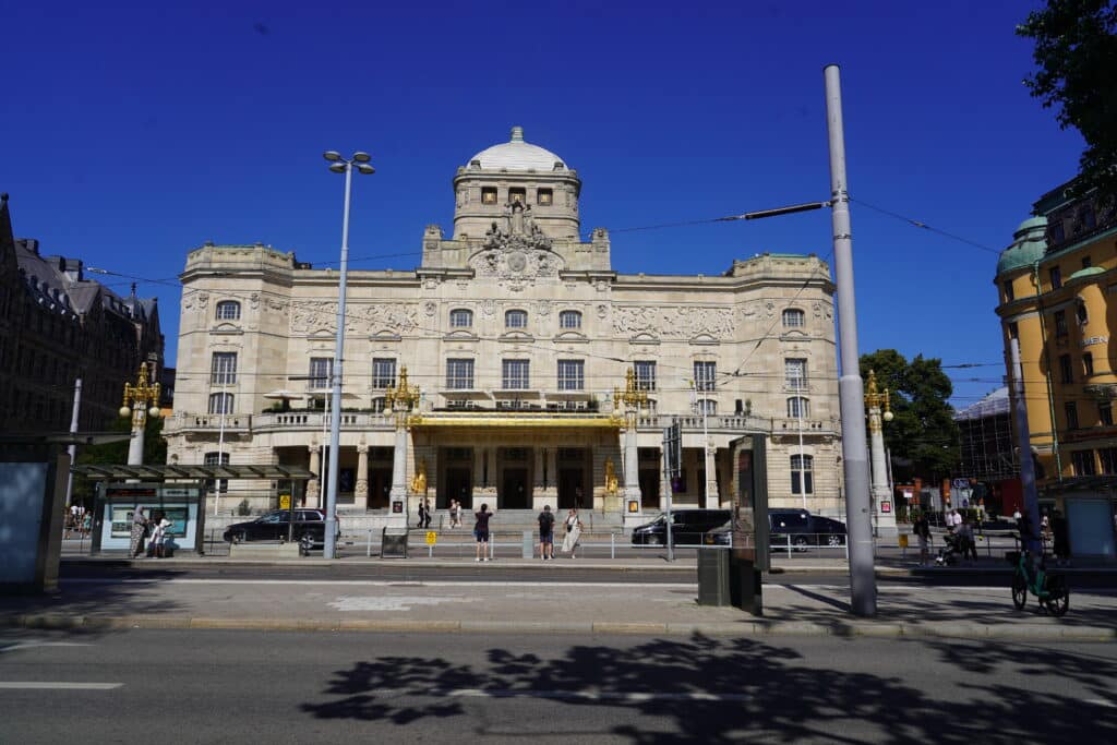 Facade of the Royal Dramatic Theatre at Nybroplan in Stockholm with a tram stop in the foreground