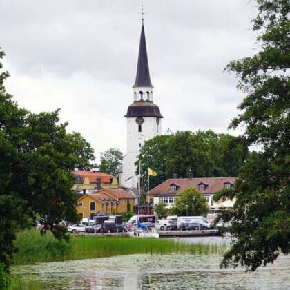 Mariefred church steeple rising above the harbor and yellow houses