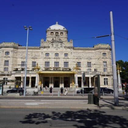 Facade of the Royal Dramatic Theatre at Nybroplan in Stockholm with a tram stop in the foreground