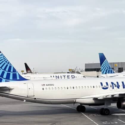 United Airlines Airbus aircraft on the ramp alongside Boeing narrowbody aircraft under an overcast sky.